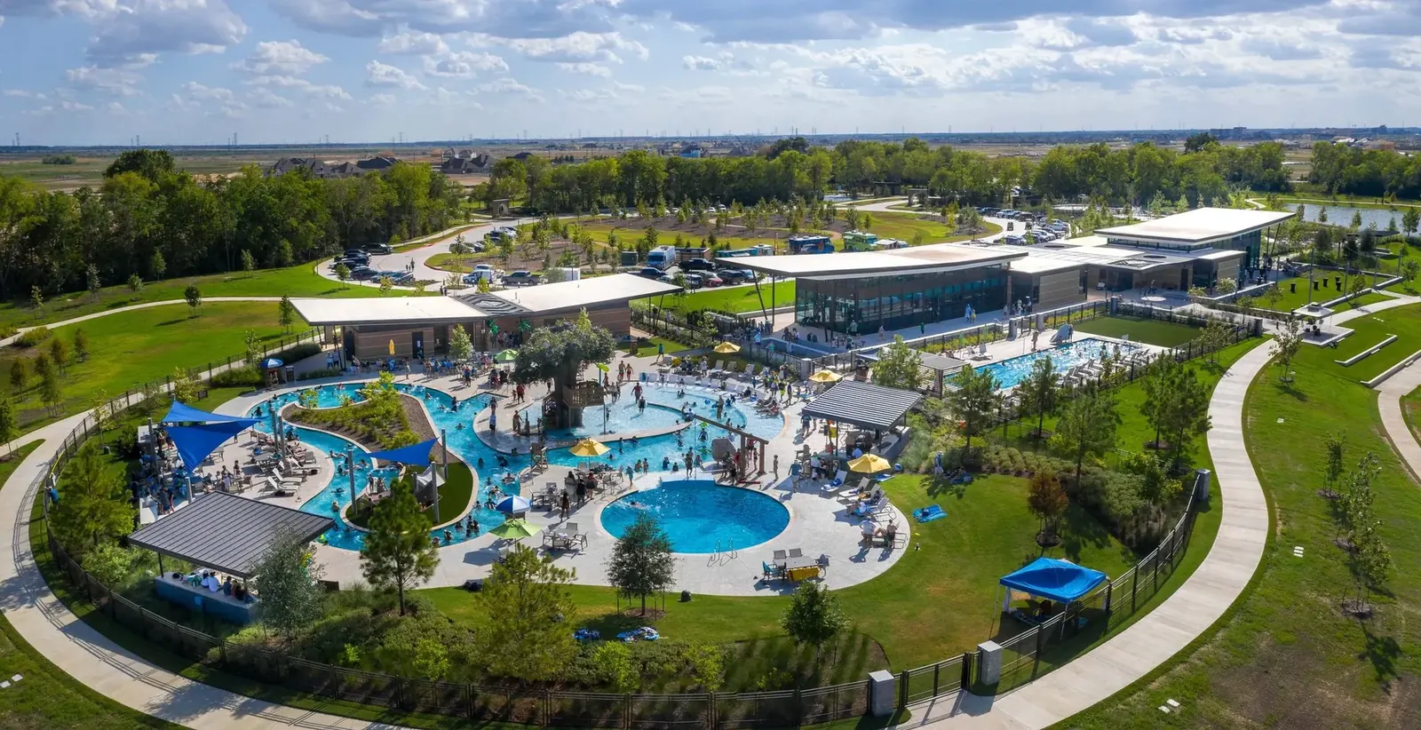 Aerial of Dragonfly Park pools, clubhouse, and lawns in Bridgeland