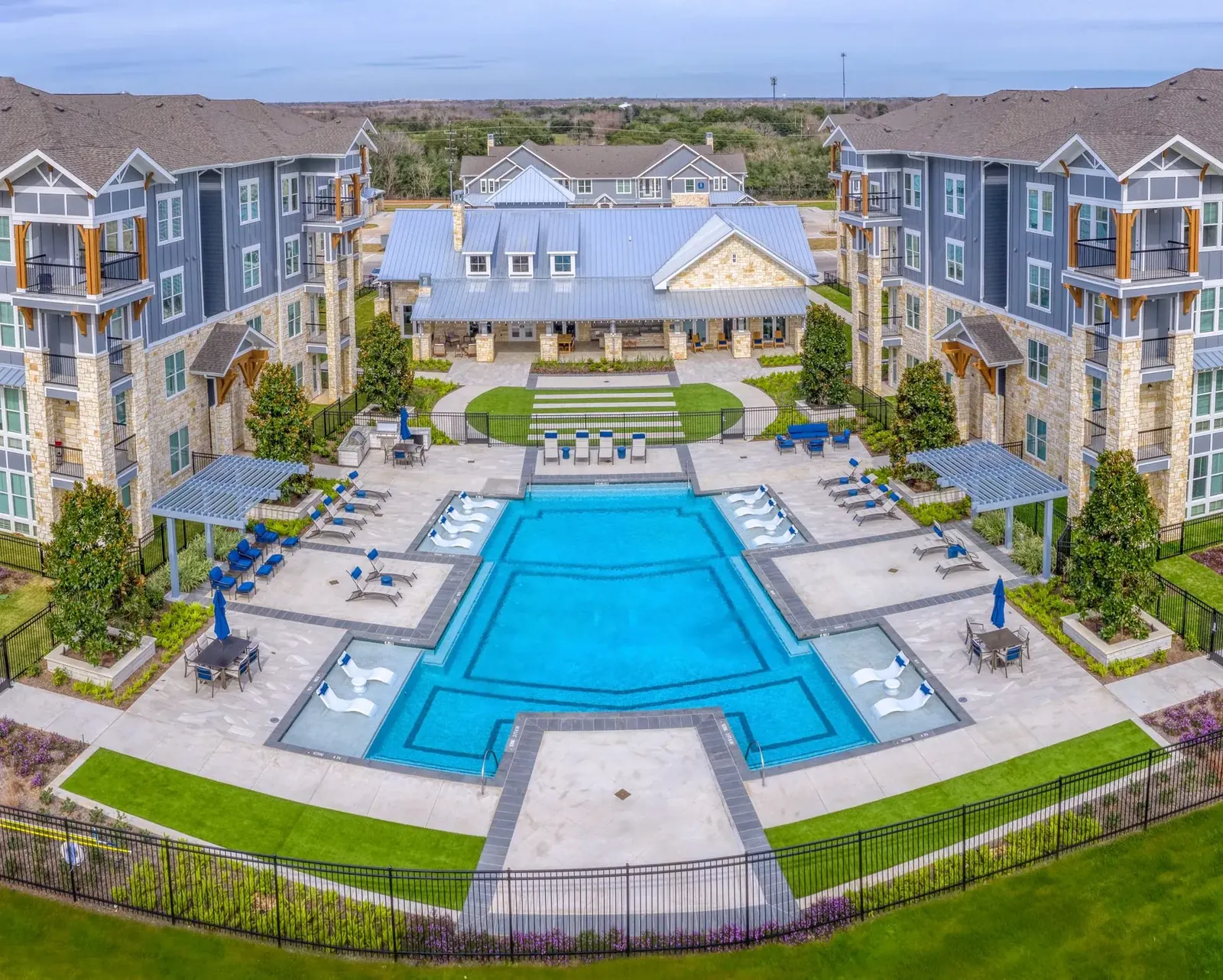 Resort-style apartment pool courtyard with cabanas and lounge seating