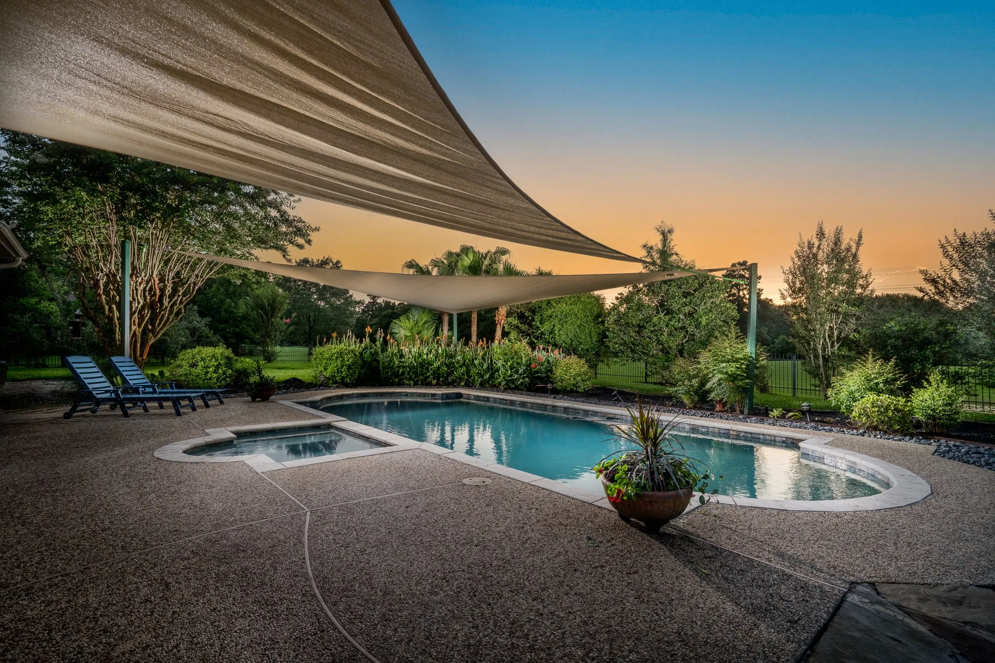 Two-story brick home at twilight on Oakmoss Trail, Bridgeland